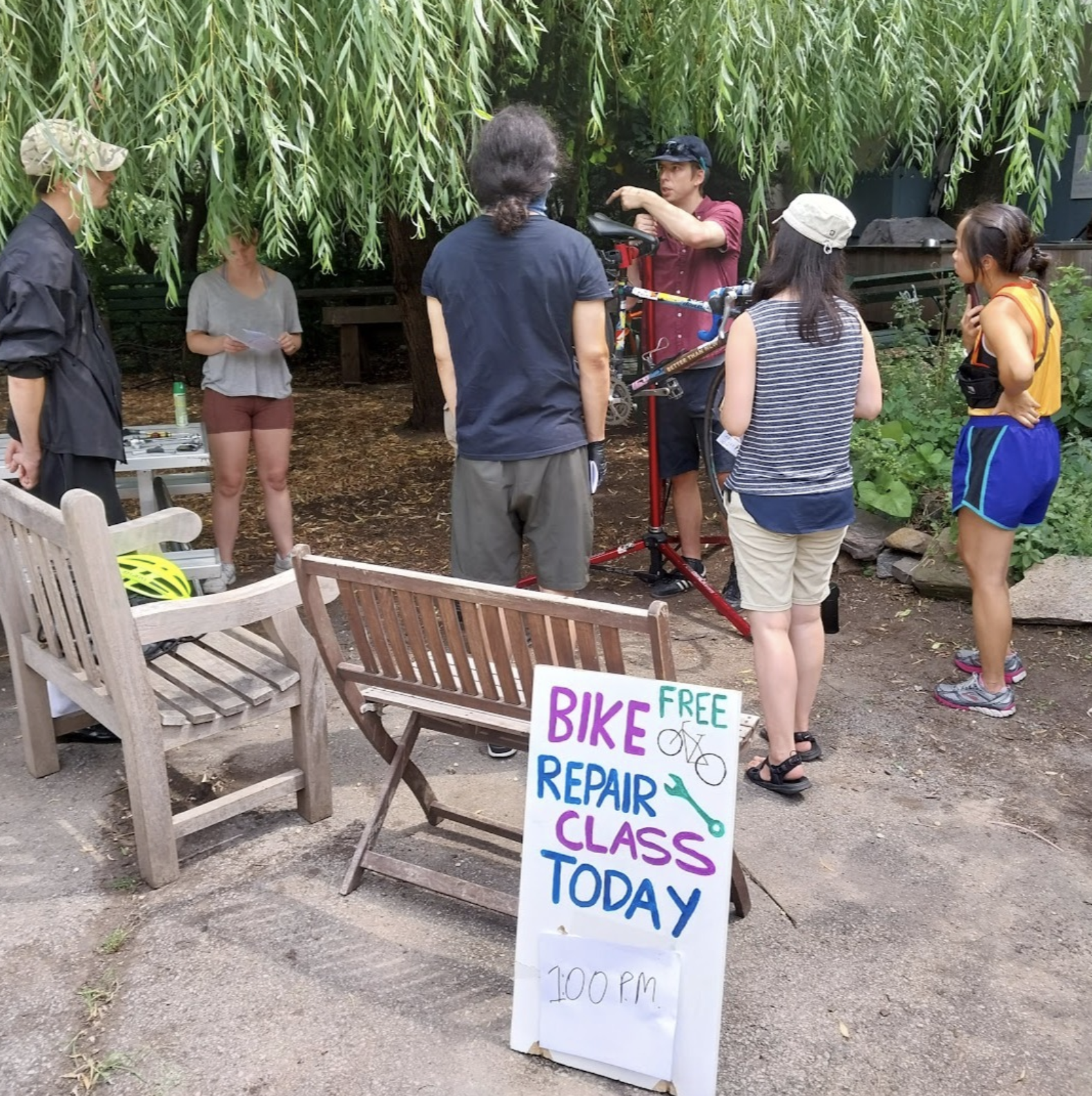 Volunteers leading a bicycle repair class